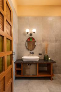 a bathroom with a sink and a mirror at SaffronStays Maitri in Igatpuri