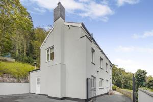 a white building with a tower on top at 4 Bed in Aberdovey oc-p33131 in Scyborycoed