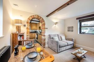 a living room with a table and a couch at 1 Bed in Uldale oc-g34032 in Uldale