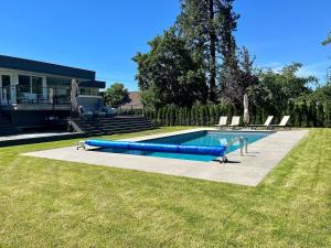 einen Pool mit blauen Schlauchkörpern in einem Hof in der Unterkunft Camelia Home in Kelowna