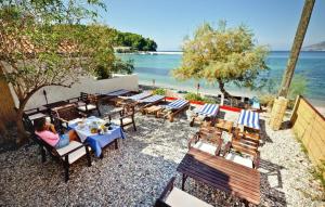 a group of tables and chairs on the beach at Rooms by the sea Zuljana, Peljesac - 3163 in Žuljana
