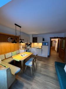a living room with a table and a kitchen at Pittlanderhof in Innsbruck