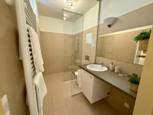 a bathroom with a sink and a mirror at Giardino Airport Apartment with garden in Schwechat