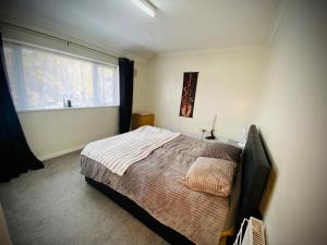 a bedroom with a bed and a television in it at Modern-privateGarden-Family-20MinToLDN in Stevenage