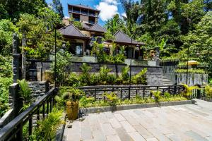 una casa con un jardín delante de ella en Ellena Resort Tegallalang by Dhananjaya Hospitality, en Tampaksiring