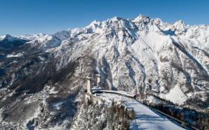 a snow covered mountain with a train on it at La Casetta del Picchio in Caspoggio