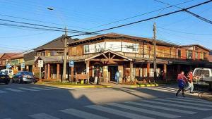 an old building on the corner of a street at Cabañas Mami Kiki in Panguipulli