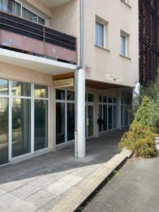 an external view of a building with glass doors at L'Ambre - Moderne - Equipé - Douche in Lourdes