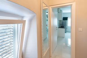 a hallway with a mirror and a refrigerator at Apartments by the sea Poljana, Ugljan - 8419 in Poljana +23 photos