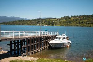 a boat is docked next to a pier at Cabañas Mami Kiki in Panguipulli +14 photos