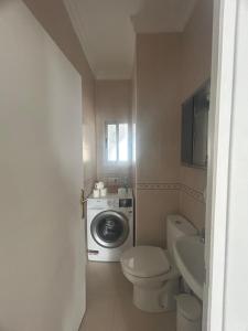a bathroom with a washing machine and a toilet at Apartament Mariola in Calpe +27 photos
