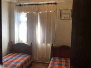 En eller flere senge i et værelse på Ed Verdes Mares Prainha Arraial