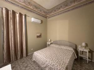 a bedroom with a bed and a ceiling at Artop in Messina