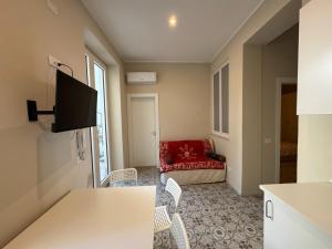 a living room with a red chair and a couch at Artop in Messina
