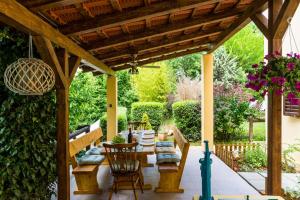 an outdoor patio with a wooden pergola at Family friendly house with a swimming pool Vojnic Sinjski, Zagora - 17375 in Trilj