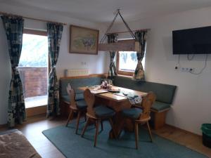 a dining room with a table and chairs at Wohnung Waldeslust In St Sigmund Im Sellrain in Sankt Sigmund im Sellrain
