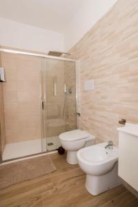 a bathroom with a shower and a toilet and a sink at IL CENTRO rooms in Cerignola +5 photos