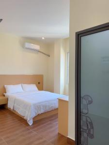 Postel nebo postele na pokoji v ubytování PANDA HOTEL Vientiane