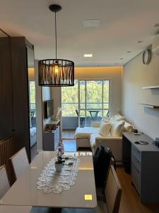 a living room with a table and a couch at Denny Prime Loft - Executive Apartment in Extrema in Extrema +30 photos