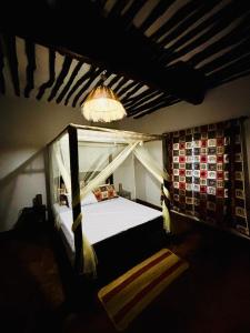 a bedroom with a bed and a chandelier at Villa Kazungu in Ukunda