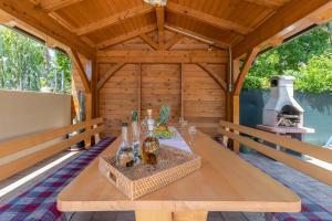 a wooden table in a cabin with a fireplace at Family friendly house with a swimming pool Jadranovo, Crikvenica - 22273 in Jadranovo