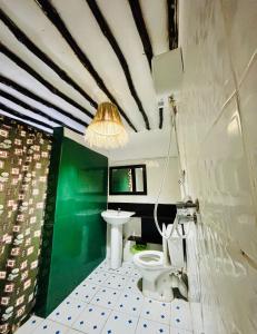 a bathroom with a toilet and a sink at Villa Kazungu in Ukunda