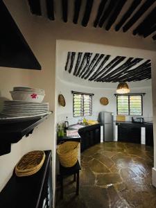 a kitchen with a stove and a counter top at Villa Kazungu in Ukunda +6 photos