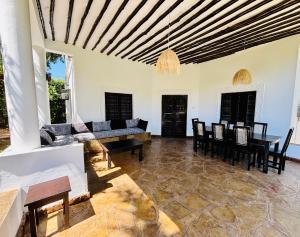 a living room with a couch and a table at Villa Kazungu in Ukunda