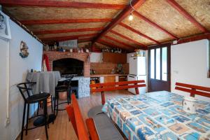 a room with a kitchen with a table and a fireplace at Apartments with parking space Palit, Rab - 22676 in Rab