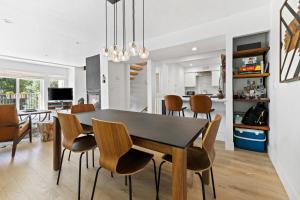 a dining room and kitchen with a table and chairs at Modern Alpine Retreat at Vail in Vail