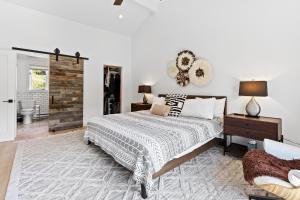 a bedroom with a bed and a table with a lamp at Modern Alpine Retreat at Vail in Vail