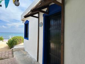 a door to a house with the ocean in the background at "Casitas Arcoiris" Excelente ubicación - Petfriendly in Isla Mujeres