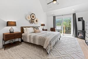 a bedroom with a bed and a large window at Modern Alpine Retreat at Vail in Vail