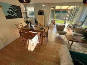 un soggiorno con tavolo da pranzo e sedie di Vakantiebungalow Vrijzicht a Kortgene
