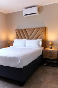 a bedroom with a large bed with a white bedspread at Cozy 1-Bed Apartment in Gaborone in Gaborone