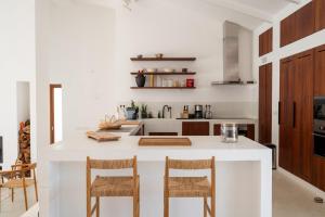 a kitchen with a white counter and wooden cabinets at Monte de Torquines - Casa de Campo com piscina em Odemira in Odemira +28 photos