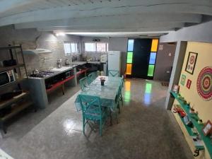 a kitchen with a table and chairs in a room at El Kamaruco Hostel in El Chalten