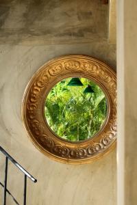 a circular window on a wall in a building at Casba Hostel in Las Terrenas +45 photos