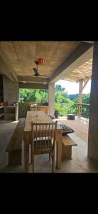 a dining room with a wooden table and a wooden chair at Casba Hostel in Las Terrenas