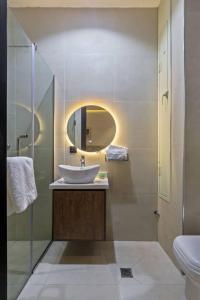 a bathroom with a sink and a mirror at Yomsdale Air B N B in Lekki