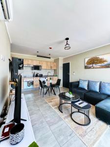 a living room with a couch and a table at Cozy 1-Bed Apartment in Gaborone in Gaborone