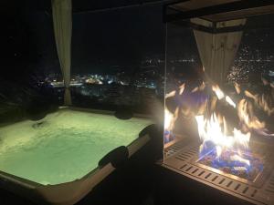 a swimming pool with a fire pit at night at Casa Ronco Frati, piscina vista lago in Pisogne