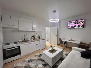 a kitchen and living room with a couch and a table at Central DELUXE Apartment in Prilep