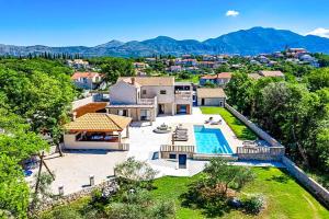 an aerial view of a house with a swimming pool at Midnight Serenity in Čilipi