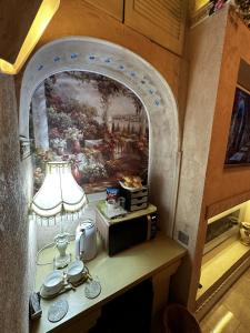 a table with a microwave and a lamp on it at Spend this night in Venice whilst visiting Swansea in Swansea