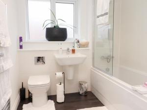 a bathroom with a toilet and a sink and a shower at Mellings Place in Carnforth +22 photos