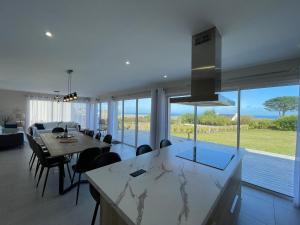 a kitchen and dining room with a view of the ocean at T'Albert Einstein in Pleubian +70 photos