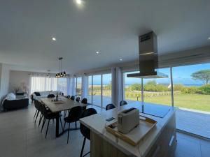 a kitchen and dining room with a view of the ocean at T'Albert Einstein in Pleubian
