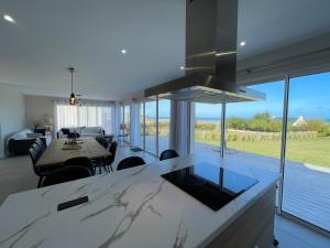 a kitchen and living room with a view of the ocean at T'Albert Einstein in Pleubian