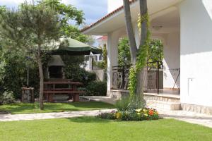 a house with a garden with a table and a grill at Apartments and rooms with parking space Krk - 3231 in Vrh